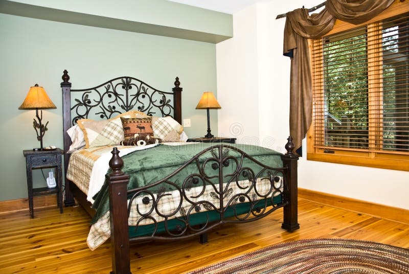 A beautiful modern bedroom with some rustic decor added in the curtain rods and bedside lamp. The floors are heart pine. A beautiful modern bedroom with some rustic decor added in the curtain rods and bedside lamp. The floors are heart pine.