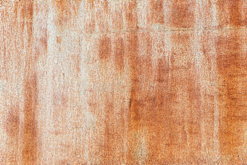 Rusty background. Old rusty metal sheet. Light brown with streaks of a rusty wall of the garage. Brown Grunge texture. royalty free stock photos