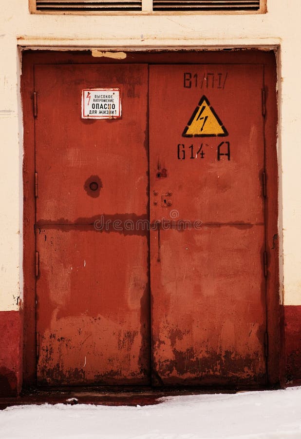 Rusty door, danger high voltage stock images