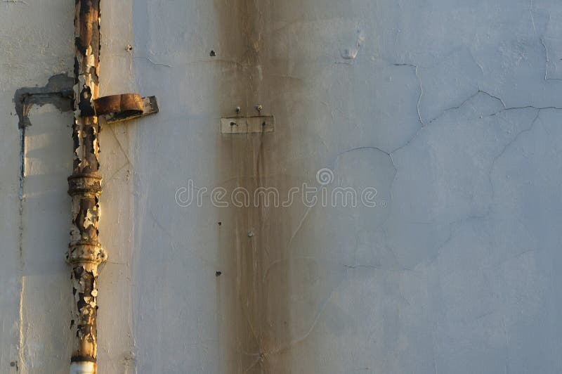 Rusty Drain Pipe. Rusty Drain Pipe with Paint Peeling Off is Light Up by the Setting Sun.. Stock