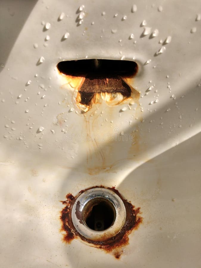 Rusty Drain And Sink Overflow Hole In An Old Porcelain Sink