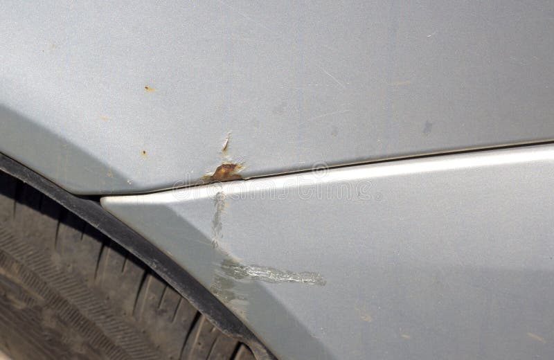 Rusty gray car detail, rust circles on car wheel fender. royalty free stock photo
