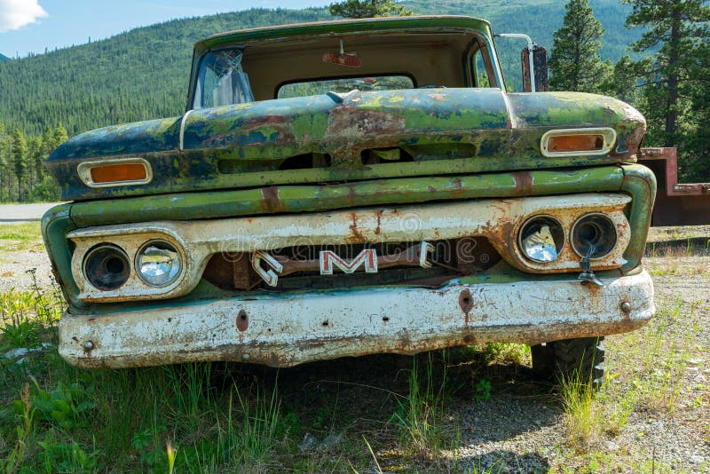 A rusty green GMC pickup in a junkyard in Cassiar, British Columbia, Canada. Cassiar, British Columbia, Canada - July 24, 2017: A rusty green GMC pickup in a royalty free stock image A rusty green GMC pickup in a junkyard in Cassiar, British Columbia, Canada. Cassiar, British Columbia, Canada - July 24, 2017: A rusty green GMC pickup in a royalty free stock image
