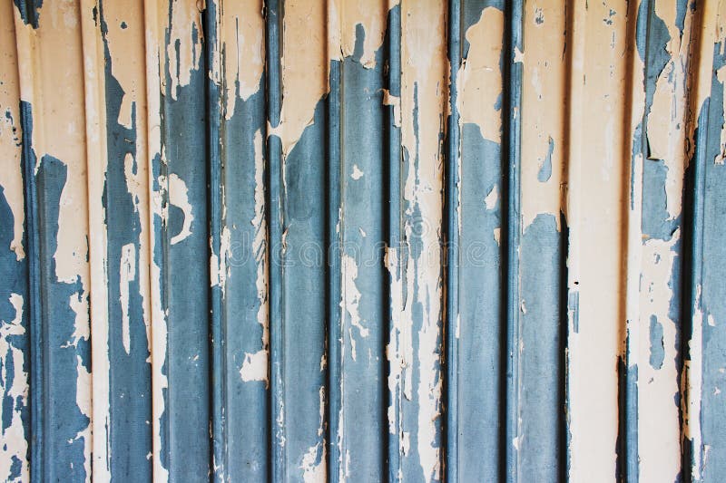 Rusty grooved galvanized metal sheet texture with remnants of old white paints and vertical ribs as background with copy space for royalty free stock images Rusty grooved galvanized metal sheet texture with remnants of old white paints and vertical ribs as background with copy space for royalty free stock images