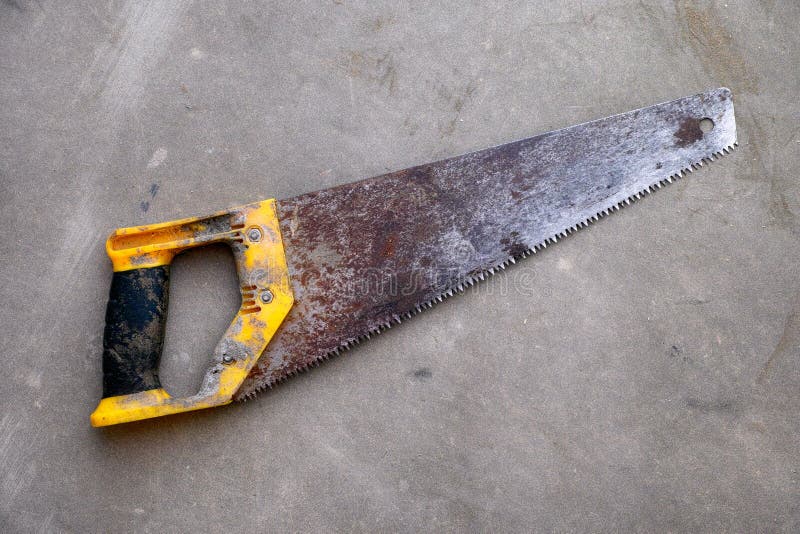 Rusty hand saw on gray background. royalty free stock images