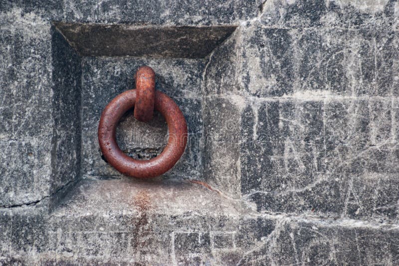 Rusty iron ring in concrete wall