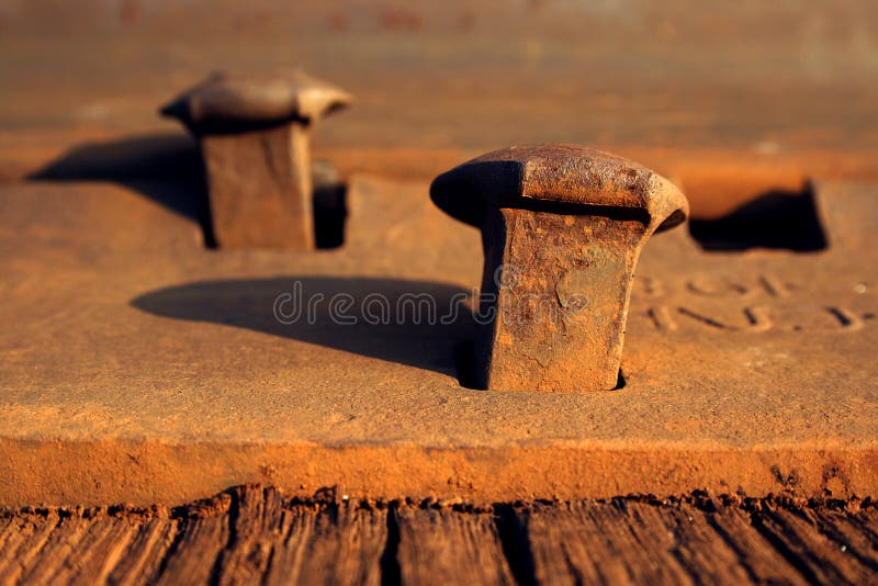 Rusty nails on a railroad track