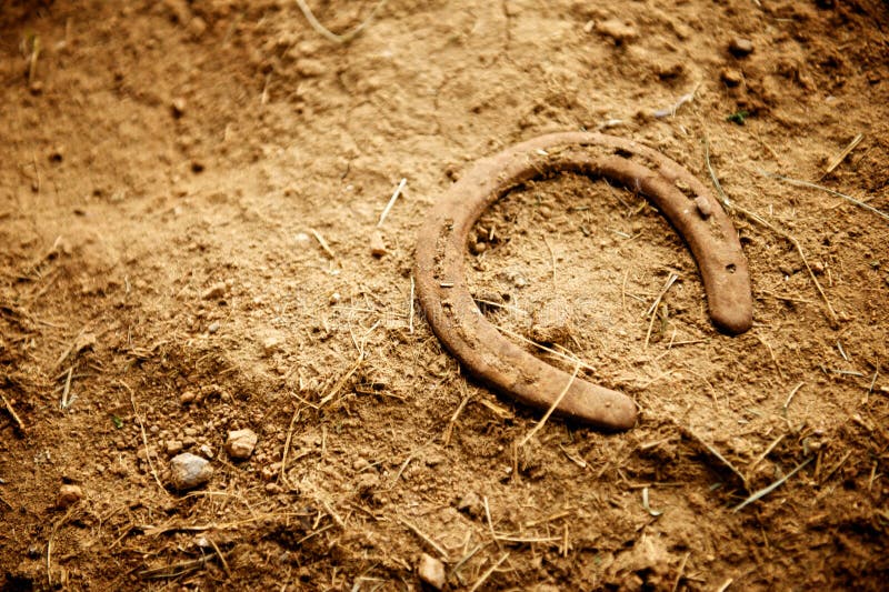 Rusty Old Horse Shoe Lying in Dirt