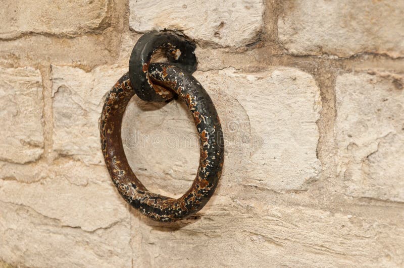 Rusty old ring at a brickwork wall