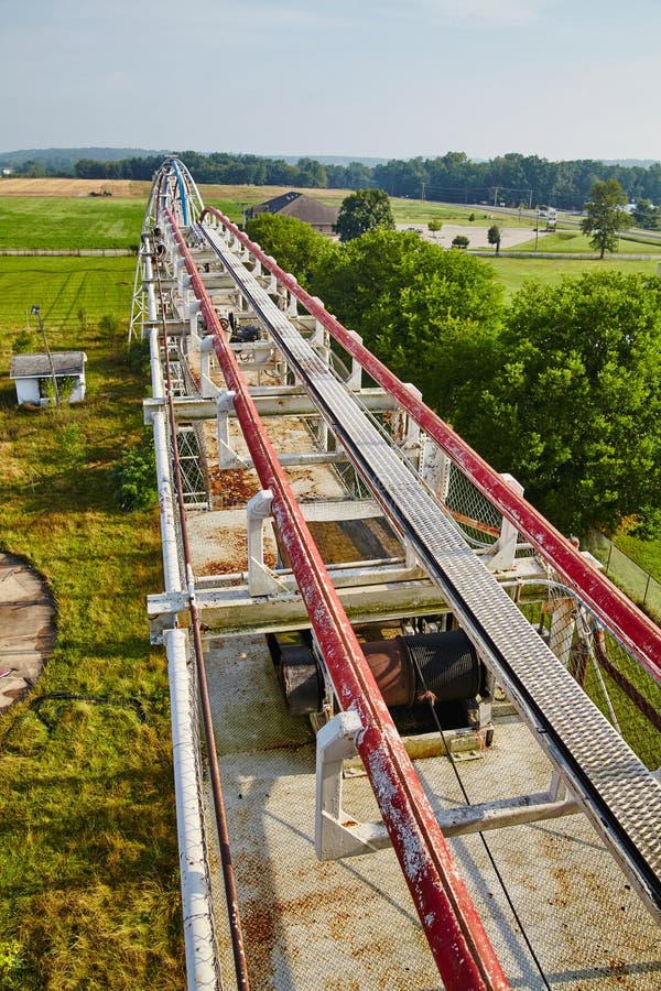 Rusty Roller Coaster Track Amidst Green Landscape, High-Angle View