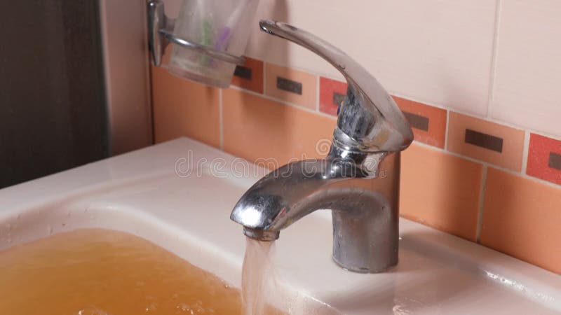 Rusty Water Pours From Tap. Water Pollution. Global Environment stock video footage