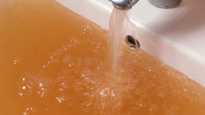 Rusty Water Pours From Tap. Water Pollution. Global Environment stock video