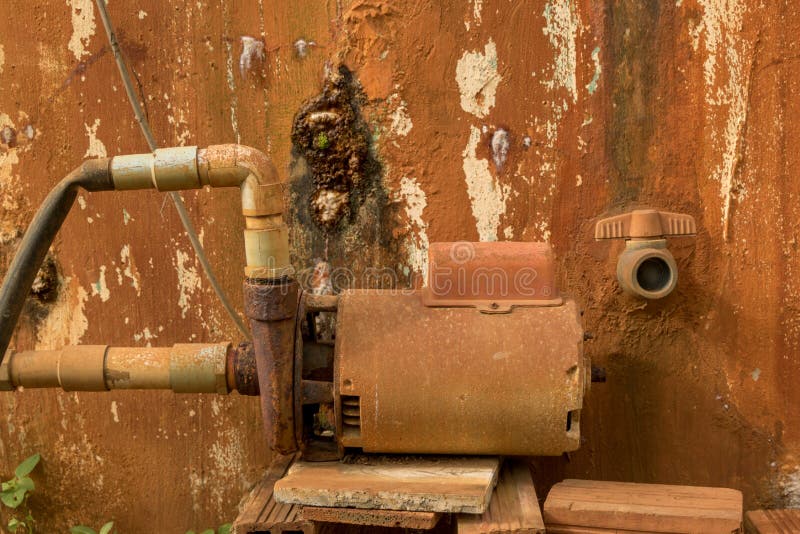 Rusty Water Turbine Generator - Moldy Peeled Concrete Wall Texture/ Vintage Garden stock images Rusty Water Turbine Generator - Moldy Peeled Concrete Wall Texture/ Vintage Garden stock images