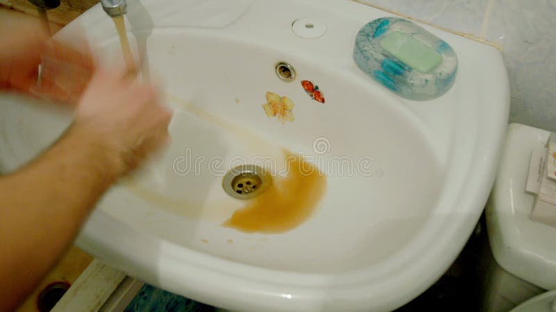 Rusty water what run from a faucet in bathroom stock video