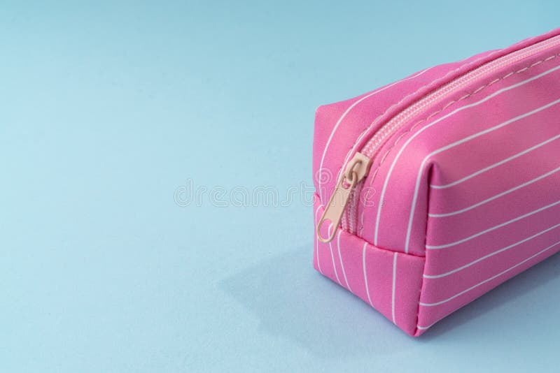 Pink color pencil box on light blue background. Pink color pencil box on light blue background. Pink color pencil box on light blue background. Pink color pencil box on light blue background.