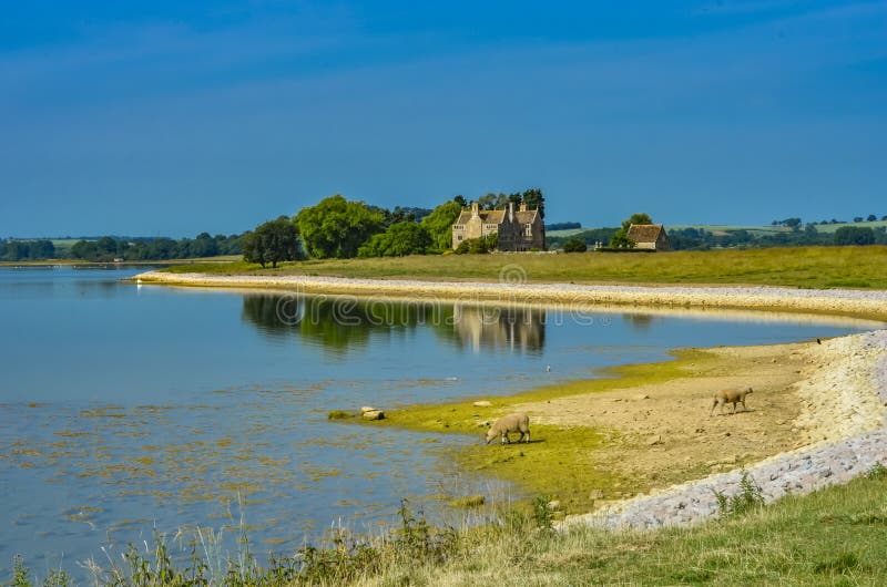 Rutland Water a large reservoir in Leicestershire in the summer with ruins in the distance. Ruins and shoreline of Rutland Water a large reservoir in royalty free stock photo Rutland Water a large reservoir in Leicestershire in the summer with ruins in the distance. Ruins and shoreline of Rutland Water a large reservoir in royalty free stock photo