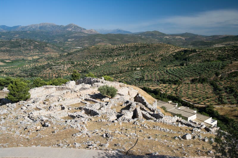 ruins of archaeological excavations of Mycenae on background view of cultivated land. ruins of archaeological excavations of Mycenae on background view of cultivated land