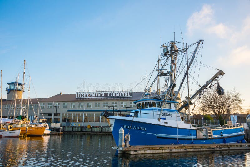 SEATTLE, WA - JANUARY 26, 2014: Commercial fishing vessels moored at Port of Seattle Fishermen's Terminal, both a working dock and tourist attraction. The terminal celebrates 100 years in 2014. SEATTLE, WA - JANUARY 26, 2014: Commercial fishing vessels moored at Port of Seattle Fishermen's Terminal, both a working dock and tourist attraction. The terminal celebrates 100 years in 2014.