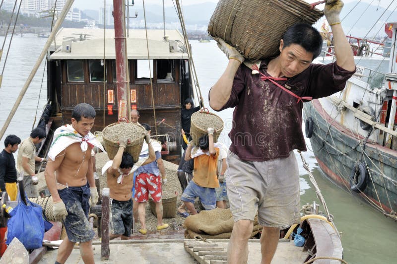 Workers in handling goods in fish pier in xiangzhou fish pier, zhuhai city, south china. photo taken on 25th Feb.2011. Workers in handling goods in fish pier in xiangzhou fish pier, zhuhai city, south china. photo taken on 25th Feb.2011