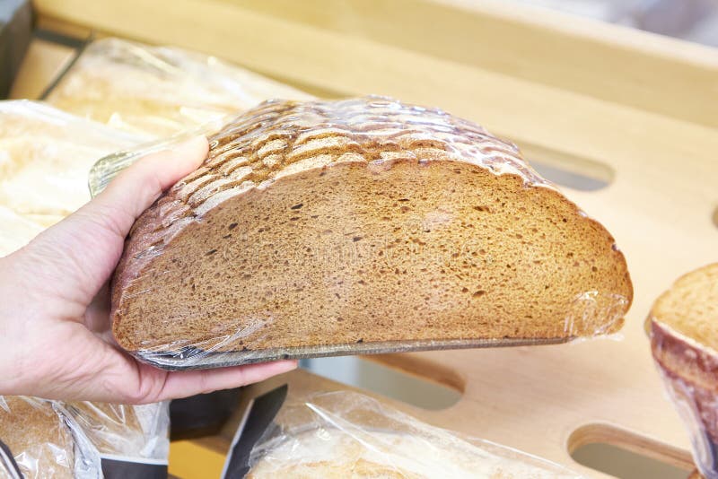 Rye bread in hand stock image. Image of wheat, flour 264687165