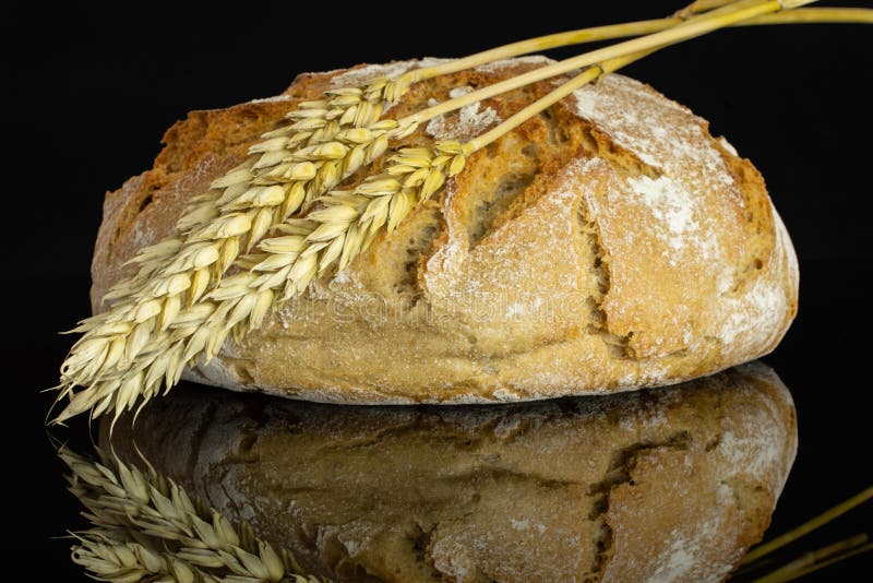 Rye wheat bread isolated on black glass