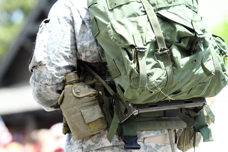 A military man walks the Huntington Beach CA USA Fourth of July Parade with his gear. A military man walks the Huntington Beach CA USA Fourth of July Parade with his gear.