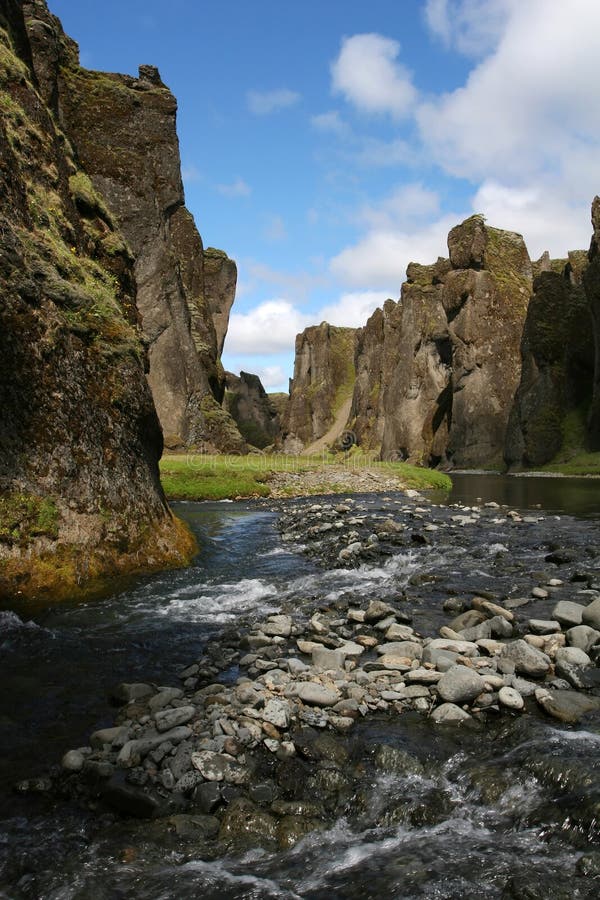 Magnificent scenic from inside a river canyon in southern Iceland, cliffs on all sides, and blue sky above. Magnificent scenic from inside a river canyon in southern Iceland, cliffs on all sides, and blue sky above