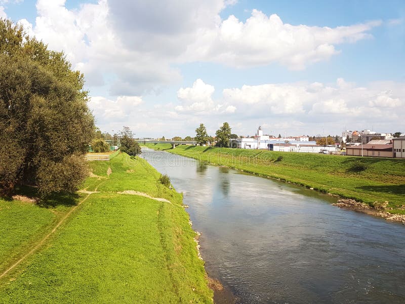 Rzeszow, Poland: city promenade. Wislock river on a summer sunny day. Park for walking citizens with a racetrack. Walk outdoors. royalty free stock images Rzeszow, Poland: city promenade. Wislock river on a summer sunny day. Park for walking citizens with a racetrack. Walk outdoors. royalty free stock images