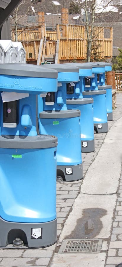 Row of Outdoor Portable Hand Sanitizer Stations next to porta potty to wash hands. Row of Outdoor Portable Hand Sanitizer Stations next to porta potty to wash hands.