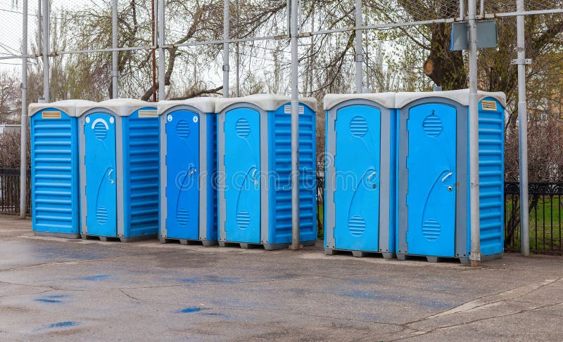 Row of portable toilets on the outdoor. Row of portable toilets on the outdoor