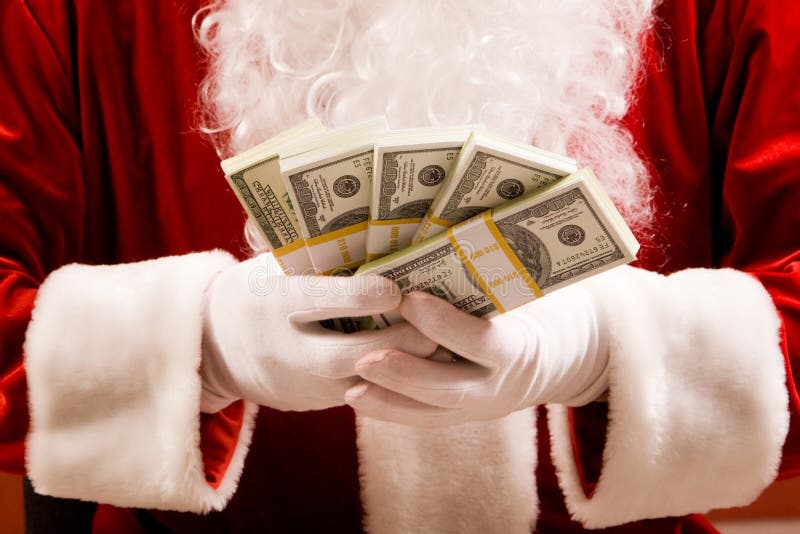 Close-up of Santaï¿½s hands with stacks of dollar banknotes. Close-up of Santaï¿½s hands with stacks of dollar banknotes