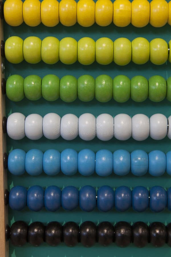 Abacus counting frame. Calculating tool with rainbow colored beads sliding on wires. Used in pre- and in elementary schools as an aid in teaching the numeral system and arithmetic or as toy. Abacus counting frame. Calculating tool with rainbow colored beads sliding on wires. Used in pre- and in elementary schools as an aid in teaching the numeral system and arithmetic or as toy.