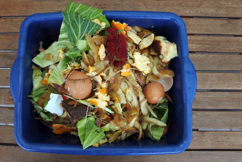 Flat lay view of container full of domestic food waste, ready to be composted in the home garden. Food recycling and environment concept. copy space. Flat lay view of container full of domestic food waste, ready to be composted in the home garden. Food recycling and environment concept. copy space