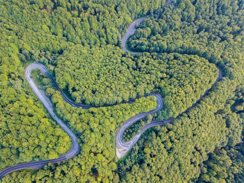 Transfagarasan national road DN7C connecting regions of Transylvania and Wallachia. Winding asphalt paved road in woods of Carpathian mountains, Romania. Transfăgărășan. Aerial drone view. Map view. Transfagarasan national road DN7C connecting regions of Transylvania and Wallachia. Winding asphalt paved road in woods of Carpathian mountains, Romania. Transfăgărășan. Aerial drone view. Map view