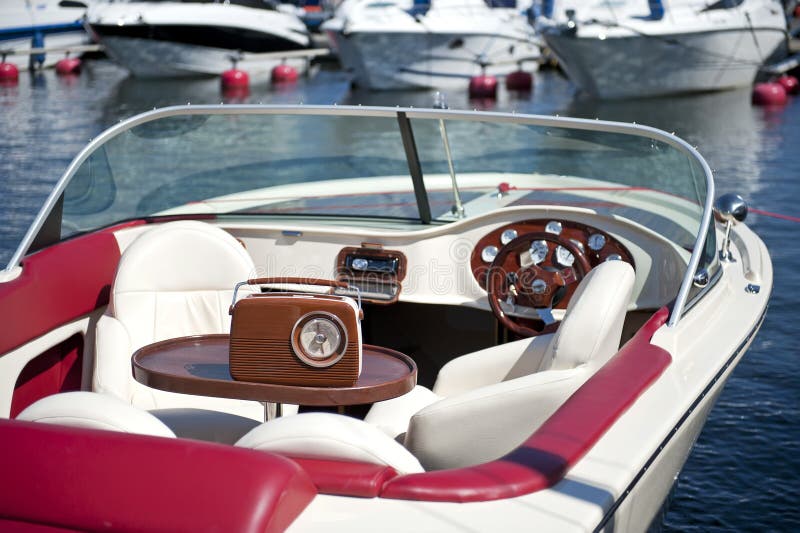 Retro motor boat close-up. Old-fashioned wooden radio on the table. Retro motor boat close-up. Old-fashioned wooden radio on the table.