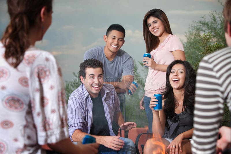 Group of six happy young people socialize outside. Group of six happy young people socialize outside