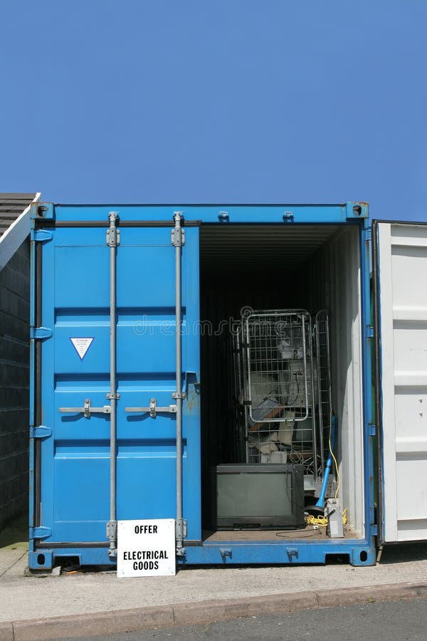 Blue metal recycling container for electrical goods, set against a blue sky. Blue metal recycling container for electrical goods, set against a blue sky.