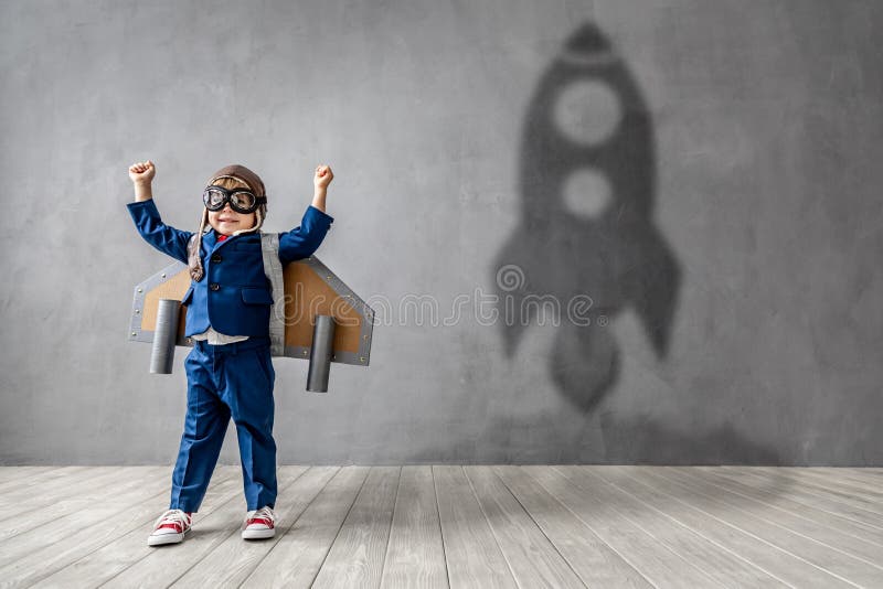 Hapy child wants to become a astronaut. Funny kid dreams of becoming a rocket pilot. Imagination and motivation concept. Hapy child wants to become a astronaut. Funny kid dreams of becoming a rocket pilot. Imagination and motivation concept