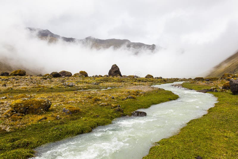 Río y nubes en el valle de Collanes en volcán del altar del EL foto de archivo Río y nubes en el valle de Collanes en volcán del altar del EL foto de archivo
