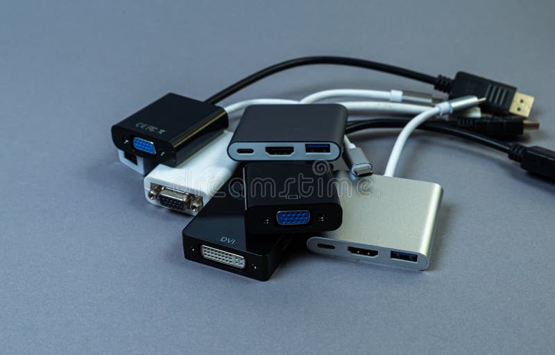 USB Type C adapter or hub with various accessories - pendrives, hdmi, ethernet, memory card, cables. Hands holding various converter cables for computers and smartphones. USB Type C adapter or hub with various accessories - pendrives, hdmi, ethernet, memory card, cables. Hands holding various converter cables for computers and smartphones