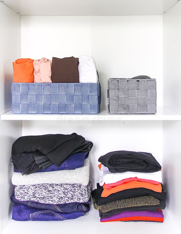 Different clothes in home wardrobe with paper notes. Small space organization. Vertical storage. Roll-out shirts in fabric boxes, interior, mess, pants, australian, beige, belt, built, cleaning, closet, contemporary, cupboard, disorder, door, drawer, female, fly, lady, hang, house, huge, large, lavish, maintaining, melamine, neat, pull-out, racks, residence, saving, shelving, skirts, spacious, store, stylish, tidy, tie, walk, warm, apparel, background. Different clothes in home wardrobe with paper notes. Small space organization. Vertical storage. Roll-out shirts in fabric boxes, interior, mess, pants, australian, beige, belt, built, cleaning, closet, contemporary, cupboard, disorder, door, drawer, female, fly, lady, hang, house, huge, large, lavish, maintaining, melamine, neat, pull-out, racks, residence, saving, shelving, skirts, spacious, store, stylish, tidy, tie, walk, warm, apparel, background