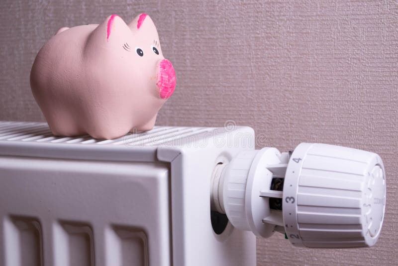 Różowa prosiątko banka oszczędzania elektryczność i grzejni koszty, zamykamy up zdjęcia stock Różowa prosiątko banka oszczędzania elektryczność i grzejni koszty, zamykamy up zdjęcia stock