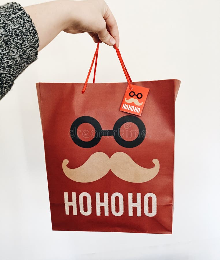 Röd jul hänger löst att likna jultomten med Ho Ho Ho arkivbild Röd jul hänger löst att likna jultomten med Ho Ho Ho arkivbild