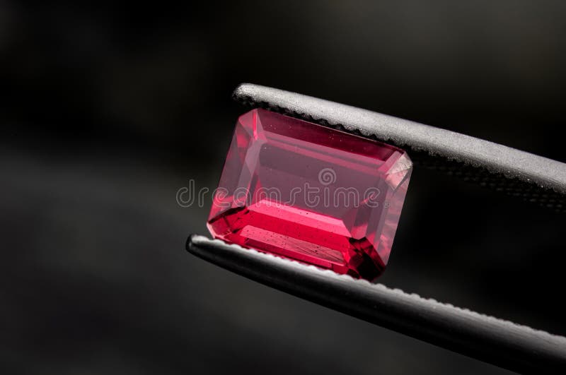 Röd ruby-gemstone med mörk rock royaltyfri bild