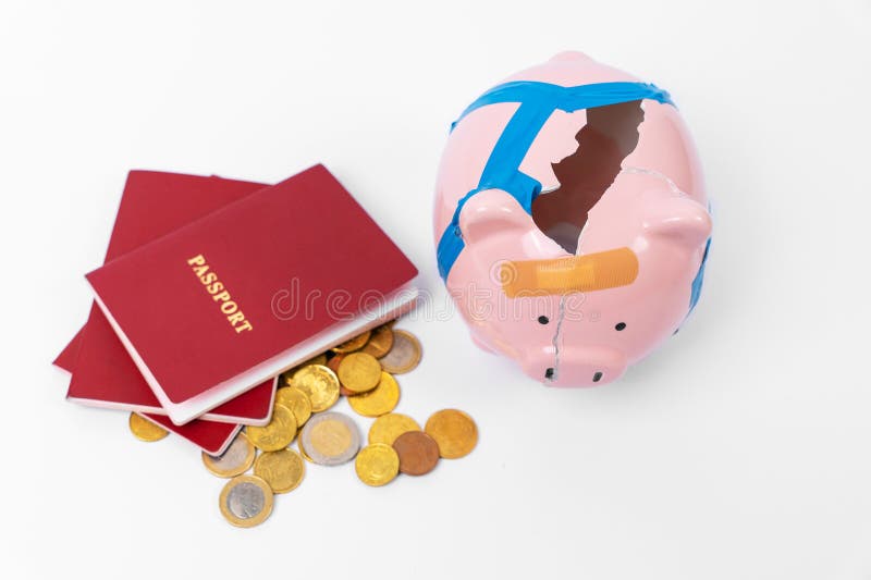 Broken piggy bank, money iron coins, red passport. Concept of moving abroad, legalization, residence permit, buying fake documents. Costs for relocation, emigration, sanction, confiscation of finances. Broken piggy bank, money iron coins, red passport. Concept of moving abroad, legalization, residence permit, buying fake documents. Costs for relocation, emigration, sanction, confiscation of finances