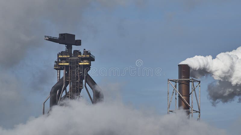 The smoke coming out of factories in an industrial area. The smoke coming out of factories in an industrial area