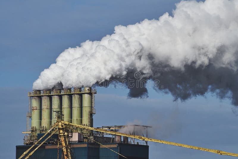 The smoke coming out of factories in an industrial area. The smoke coming out of factories in an industrial area