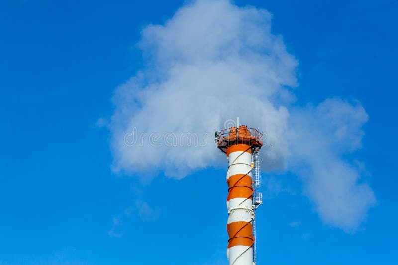 Smoke pollution. Smoke pipes against the blue sky. Smoke pollution. Smoke pipes against the blue sky.