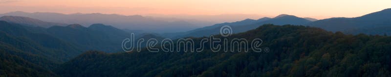 Rökig solnedgång för bergpanorama