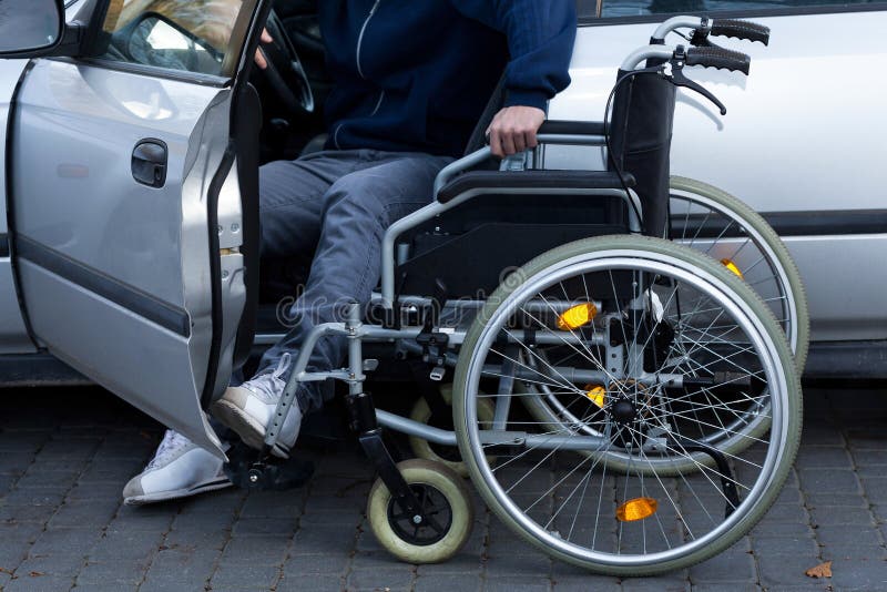 Disabled man preparing to drive a car, horizontal. Disabled man preparing to drive a car, horizontal